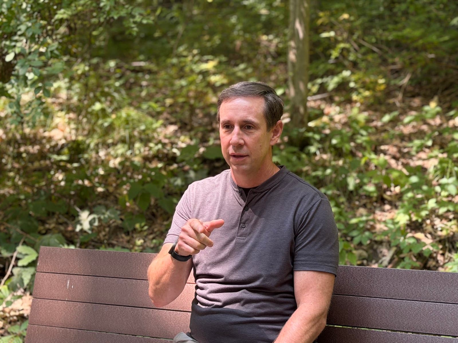 Gregg Huffman in conversation on a trail bench